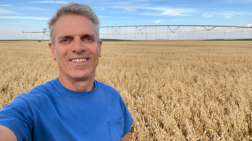 Man wearing a blue shirt in a field